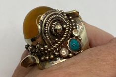 Huge amber and turquoise tribal ring Lovely polished brass has the look of antique gold Size 9.5 but is adjustable My jeweler can re size it for a $10-$20 fee. All rings are shipped in a nice gift box. Check out our over a THOUSAND great reviews Engraving is $4 per letter and is not always perfect depending on the piece. It can take a few days if the jeweler is busy. This is payable to Paypal Judithsltd@gmail.com Gold Adjustable Turquoise Ring, Adjustable Gold Turquoise Ring, Adjustable Gold Turquoise Ring In Spiritual Style, Adjustable Gold Spiritual Turquoise Ring, Bohemian Yellow Round Rings, Handmade Gold Turquoise Ring, Unique Handmade Gold Turquoise Ring, Handmade Bohemian Gold Turquoise Ring, Handmade Gold Bohemian Turquoise Ring