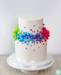 a white cake with colorful sprinkles on it