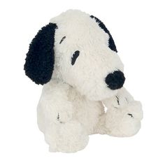 a white stuffed dog with black ears and nose