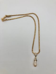 "Gorgeous, vintage, Nina Ricci necklace featuring Clear Swarovski Crystals & Faux Pearl. The pendant begins with a circle of Swarovski crystals and below hangs a shimmering large faux teardrop pearl. There is an unnoticeable amount of vintage wear on the crown holding the pearl. The 16\" chain is full of sparkle. Feel good about your purchase. All sales support building affordable homes through NSWW Habitat for Humanity!" Teardrop Crystal Necklaces For Evening, Formal Drop Necklace With Teardrop Pendant And 17 Jewels, Formal Teardrop Pendant Drop Necklace With 17 Jewels, Teardrop Crystal Necklace For Evening, Elegant Drop Necklace With Chain For Formal Occasions, Elegant Drop Chain Necklace For Formal Occasions, Elegant Formal Drop Necklace With Chain, Elegant Rhinestone Dangle Necklace With Chain, Gold Crystal Necklace With Pearl Drop