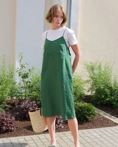 This slip linen dress MARFA in green features a straight silhouette, an open back, and versatile spaghetti straps. Tie the straps in different styles: cross them at the back with loops at the lower back or knot them above the neck for varied looks. The chest area has double fabric for added detail, and side pockets bring functionality to the design. Details: * Straight cut * Midi-length * Sleeveless * Open back design * V-neckline with narrow shoulder straps * Includes side pockets on the sides Open Back Summer Dress, Green Linen Dress, Sleeveless Linen Dress, Dress Open Back, Linen Midi Dress, Midi Length Dress, Midi Dress Sleeveless, Linen Dresses, Dress Sleeveless