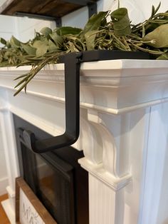 a close up of a fire place with plants on the mantel and fireplace mantle