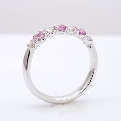 This half studded band has been set with pink sapphires and diamonds in calibrated sizes. 18k white gold holds each gem in a secure prong setting. The light pink tones are currently a trending color like the pastel colors of Rose Quartz. The perfect ring for your fashionista fiancé set with 0.57 carats of pink sapphires. Order online info@jupitergem.com Fine Jewelry Pink Diamond Ring In Platinum, Pink Cubic Zirconia Classic Ruby Ring, Pink Platinum Ruby Ring For Wedding, Pink Brilliant Cut Diamond Ring In Sterling Silver, Pink Ruby Ring With Prong Setting In Cubic Zirconia, Pink Sapphire Ring With Prong Setting In Sterling Silver, Pink Ruby Ring In Platinum, Pink Diamond Ruby Ring With Brilliant Cut, Pink Ruby Ring With Brilliant Cut Diamond