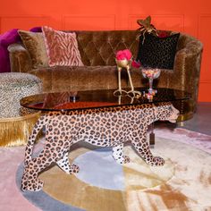 a leopard figurine sitting on top of a table in front of a couch