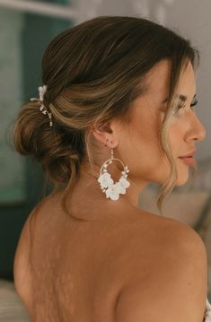 The Flora Hoops have a modern look with the aura of an heirloom. These romantic circular hoop earrings are feminine, yet bold. Decorated with light ivory ceramic blossoms and natural freshwater pearls, the Flora Earrings would be a stunning compliment to any bridal look. Details: Available finishes: gold/ Light Ivory or silver/ light ivory Ceramic Blossom color: light ivory Gold/ Silver Plated jewelry wire Attached to gold/ silver plated ear wire hooks Dimensions: 2.25x3 inches Final Sale Bridal Earrings Pearl, Light Ivory, Silver Lights, Bridal Look, Jewelry Wire, Gold Light, Silver Plated Jewelry, Floral Bridal, Bridal Pearls