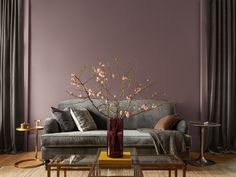 a living room with purple walls and furniture