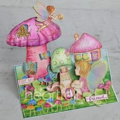 a card with an image of a fairy and mushroom house