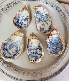 four pieces of blue and white porcelain sitting on a plate