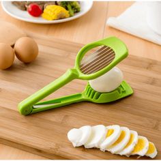 an egg slicer on a cutting board with sliced eggs