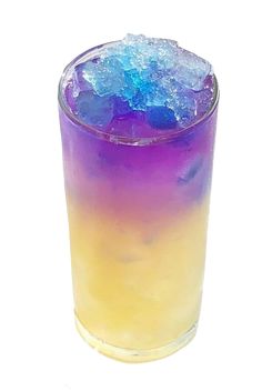 a purple and blue drink with ice on the rim, in a tall glass against a white background