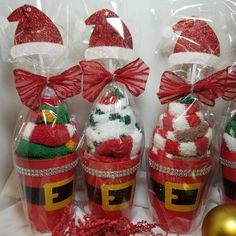 three christmas baskets with santa hats on them