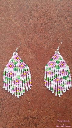 These handmade unique earrings with abstract floral print are made of high-quality Czech beads and strong synthetic thread. I use my author's scheme . These earrings are elegant, fashionable, and highly versatile, suitable for everyday wear. Color: white,pink, green, yellow . 100% hand made with love! Measurements: Length-about 7cm (with schwenze) , Width -3 cm Materials: Silver plated ear hooks Czech glass beads Nylon Thread Traditional White Flower Earrings, White Dangle Flower Earrings With Colorful Beads, White Flower Dangle Earrings With Colorful Beads, Traditional White Earrings For Summer, Traditional White Chandelier Earrings As Gift, Colorful Beaded White Chandelier Earrings, White Dangle Flower Earrings With Beads, White Teardrop Earrings For Summer, Multicolor Handmade Teardrop Flower Earrings