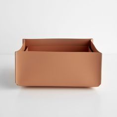 an empty leather box on a white surface