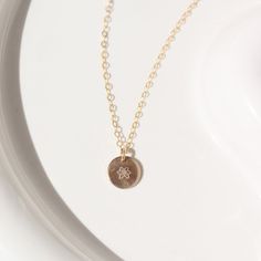 14k gold fill Tiny Birth Flower Disc Necklace laid on a white plate in the sunlight. This necklace features our simple chain with a birth flower pendent of your choice. 5 September, Big Personality, Flower Charm Necklace, Forever Jewelry, Dainty Chain, One Love, Solid Gold Jewelry, Birth Flower, Silver Spring