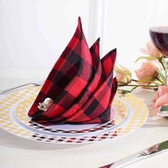 a red and black plaid napkin on a white plate