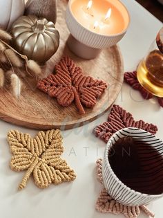 a wooden tray topped with cookies next to a candle