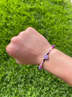 A purple flower elastic bracelet! (For kids) Casual Purple Friendship Bracelets With Round Beads, Trendy Handmade Purple Stretch Bracelet, Casual Purple Round Beads Friendship Bracelets, Trendy Purple Friendship Bracelets As Gift, Casual Purple Beaded Friendship Bracelets, Cute Purple Friendship Bracelets, Multicolor Flower Stretch Bracelet As Gift, Adjustable Purple Stretch Bracelet For Friendship, Cute Purple Friendship Bracelets As Gift