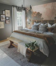 a bedroom with a large bed and pictures on the wall