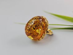 Amber ring. Brown cognac Amber. Certificated Sterling silver 925 with stamps - hallmarks. Big nice stunning ring. Adjustable size. Very big and stunning amber gemstone ring.  weight  16,82 gr GOLD plated ring.  Stone size - 3 x 2,5  cm This item was made of natural Baltic Amber. All the amber used in my jewelry is collected in my home country Lithuania.  I sell only genuine,  real, not pressed, authentic, natural Baltic Amber. Item may have natural imperfections.