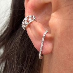 a close up of a person's ear with a ring on top of it