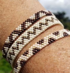 a close up of a person wearing three bracelets