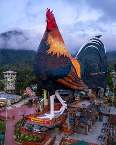 a large rooster statue on top of a building