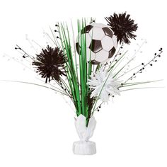 a vase filled with flowers and a soccer ball