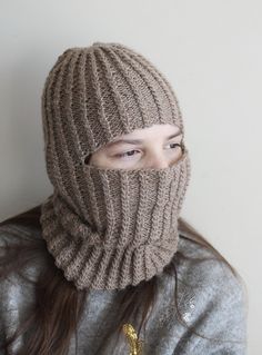 Embrace the winter chill with our exquisite handmade, knitted unisex balaclava, thoughtfully crafted from lightweight and warm alpaca wool yarn. Designed to fit both teens and adults comfortably, this balaclava is the epitome of style and functionality. Its luxurious texture, delicately adorned with a mesmerizing cable pattern, adds a touch of elegance to your winter wardrobe. Indulge in the unparalleled softness and insulating properties of alpaca wool, keeping you cozy and snug during the coldest of days. Despite its incredible warmth, the lightweight nature of the balaclava ensures breathability, preventing you from feeling stuffy or uncomfortable. Whether you're conquering snowy peaks, taking a serene winter walk, or simply relishing the crisp air, our balaclava promises to be your tru Winter Alpaca Knitting Pattern, Cozy Hand Knitted Balaclava For Outdoor, Brown Knitted Pattern For Winter, Hand Knitted Brown Winter Knitting Pattern, Winter Warm Knitting Pattern With Acrylic Yarn, Warm Winter Knitting Pattern In Acrylic Yarn, Winter Warm Acrylic Yarn Knitting Pattern, Warm Acrylic Yarn Knitting Pattern For Winter, Knitted Balaclava For Cold Weather, One Size