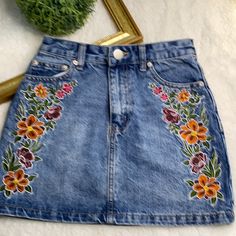 Forever 21 Jean Skirt With Embroidered Flowers Gently Used! Beautiful Jean Skirt With Embroidered Flowers On Each Side. Please See Pictures With Measurements. Size: Xs Fitted Floral Embroidered Mini Skirt For Summer, Spring Floral Embroidered Fitted Mini Skirt, Fitted Floral Embroidered Mini Skirt For Spring, Embroidered Jean Skirt, Spring Skirt With Floral Embroidery, Summer Cotton Denim Skirt With Floral Embroidery, Casual Summer Mini Skirt With Floral Embroidery, Embroidered Cotton Mini Skirt For Summer, Summer Floral Embroidered Mini Skirt