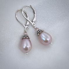 ✦Beautiful teardrop-shaped natural metallic blush pink colored pearls are adorned with intricate oxidized silver bead caps and tiny moonstone beads, and dangle from sturdy sterling silver lever back ear wires. Also available with French hook ear wires or ball post ear wires if you prefer. Please select ear wire style at check out. ✦Earring length approximately 1 inches from the top of ear wire to the bottom of the earring.  ✦Your jewelry will be packaged in a beautiful and reusable organza bag. All items will be placed in the same organza bag. If you need a separate bag for each item, please leave a comment at check out. ✦Giving your purchase as a gift? If you would prefer that prices not be printed on your invoice, please check "this item is a gift".  ✦To receive your item in a gift box w Pink Pearl Charm Jewelry For Wedding, Elegant Pink Teardrop Earrings, Classic Pink Drop Jewelry, Pink Teardrop Earrings For Formal Occasions, Feminine Teardrop Jewelry For Formal Occasions, Pink Teardrop Pearl Earrings For Wedding, Delicate Teardrop Pearl Earrings Nickel-free, Pink Feminine Pearl Earrings For Wedding, Delicate Nickel-free Teardrop Pearl Earrings