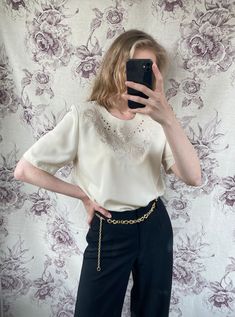 "- Vintage embroidered top - Good vintage condition - TAG SIZE: UK 10, F 38, NL 36, DK 36, A 36, L 38 - Fabric information: 100% polyester Estimated to fit XS-S-M based on your desired fit. Measurements (laying flat): - Shoulders (back) 39 cm - Length: 71 cm - Sleeve: 27 cm Vintage clothes may come with minor flaws due to pre-loved wear. But most importantly it is a one-of-a-kind piece with its own character. By shopping secondhand you're giving a second life and not contributing to the fast fas Elegant Short Sleeve Embroidered Top For Spring, Fitted Vintage Embroidered Top With Short Sleeves, Vintage Embroidered Short Sleeve Tops, Fitted Vintage Embroidered Short Sleeve Top, Vintage Short Sleeve Beige Blouse, Vintage Floral Embroidered Short Sleeve Top, Vintage Short Sleeve Ring-spun Cotton Tops, Vintage Embroidered Beige Tops, Vintage Beige V-neck Top