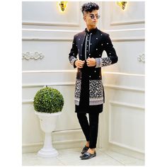 Designer Black Embroidered Kurta, Designer Embroidered Black Kurta, Designer Black Sets For Winter, Designer Black Nehru Jacket With Traditional Drape, Black Long Sleeve Designer Bandhgala, Designer Black Kurta With Resham Embroidery, Designer Sherwani With Intricate Embroidery For Winter, Designer Winter Sherwani With Intricate Embroidery, Designer Black Sets For Festivals