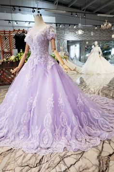 a mannequin is dressed in a purple ball gown