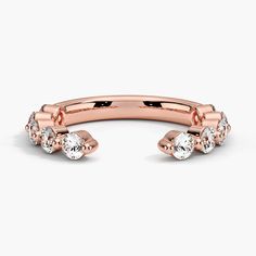 a rose gold ring with three diamonds