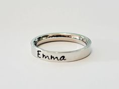 Petite name ring. Stacking name ring. Personalized name ring. This GOREOUS 3 mm ring is super shiny. Great for stacking.  The surface is flat, so the lettering really stands out!  Add names, initials, dates, quotes, roman numerals or scripture. I have the heart, double heart, infinity, #, &, @, !, =, *, :, ?, cross, baby foot, angel, and ribbon stamps. 15-character limit. Made of solid surgical Stainless steel which will never rust, tarnish, change color and is hypoallergenic.  Swim & shower saf Simple Adjustable Personalized Rings, Simple Adjustable Personalized Ring, Minimalist Customizable Rings For Personalized Gifts, Personalized Engraved Ring As Gift, Minimalist Customizable Initial Ring For Promise, Adjustable Engraved Promise Ring With Custom Name, Minimalist Custom Name Initial Ring For Promise, Simple Personalized Adjustable Rings, Minimalist Personalized Ring For Gift