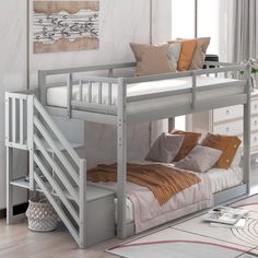 a white bunk bed with stairs in a room