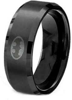 a black ring with the batman symbol on it's center and an etched logo in the middle