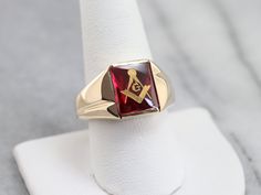 "This vintage red ruby glass Masonic ring features polished, structurally simple shoulders, and a simple rectangular shape. The center is a classic red ruby glass cabochon, inlaid with the gold Masonic symbol, with a nice flat profile. Metal: 10K Yellow Gold Gem: Ruby Glass Gem Measurements: 12.0 x 10.1 mm, Rectangle Ring Size: 12.50 Marks: \"10K\" Stamped on the inside band SKU #: NALNWC2H Each piece has been identified and graded by a Graduate Gemologist who has been certified by the Gemologic Masonic Symbol, Mens Vintage Jewelry, Gem Ruby, Rectangle Ring, Masonic Symbols, Right Hand Ring, Jewelry Mens, Masonic Ring, Best Flats