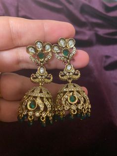 These stunning CZ Green stone Bronze finish AD Jhumkis perfectly complement any Indian outfit. The intricate design and high-quality materials make them a must-have accessory. With a bronze finish and sparkling CZ stones, they add a touch of elegance and sophistication to any look. Length - 5.5cm Jewellery Care- Keep the jewelry dry, avoid heat and contact with perfumes & water. Bridal Choker, Fancy Blouses, Indian Outfit, Green Crystal, Affordable Jewelry, American Diamond, Green Crystals, Intricate Design, Green Stone