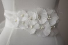 "An accessory to complement your beautiful wedding dress Flowers made of organza. The belt made organza and length is approximately 98\"dimensions, width is 2.7\". All steps were performed obtained. Pearl and rhinestone used in the middle of the flowers . Belt in the photo is the color of ivory. Please feel free to contact for questions and requests. PACKAGE ARE SENT BY FAST SHIPPING COMPANY WITHIN 3 TO 4 BUSINESS DAYS, TO UNITED STATES, TO CANADA, TO UNITED KINGDOM,TO AUSTRALIA AND ALL EUROPEAN Elegant Bridal Belt With Flower Decoration For Wedding, Elegant Bridal Belt With Handmade Flowers For Weddings, Elegant Bridal Belt With Flower Decoration, Elegant Bridal Belt With Handmade Flowers, Wedding Dress Flowers, Belt Wedding Dress, Wedding Dress Belt, Wedding Sash Belt, Wedding Dresses With Flowers