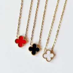 Introducing our exquisite Lucky Clover Necklaces, where elegance meets whimsy in a timeless design. Crafted with precision and passion, these necklaces feature delicate vibrant colored clover pendants adorned with gold chains, adding a modern twist to a classic symbol of luck and fortune. Each necklace is meticulously crafted from high-quality materials, ensuring durability and lasting beauty. The clover pendant hangs gracefully from a dainty chain, creating a subtle yet captivating statement piece that effortlessly enhances any ensemble. Available in an array of stunning colors, our Clover Necklaces cater to every style and preference. Whether you're dressing up for a special occasion or adding a touch of charm to your everyday look, these necklaces are the perfect accessory to complement Luxury Red Necklace For Gift, Elegant Red Jewelry With Delicate Chain, Red Pendant Necklace Gold Plated, Gold Plated Red Pendant Necklace, Red Gold Plated Pendant Necklace, Luxury Flower Pendant Necklace With Delicate Chain, Elegant Red Jewelry With Chain Detail, Elegant Red Chain Jewelry, Elegant Red Flower-shaped Jewelry