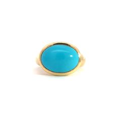 Elevate your style with the stunning Large Oval Cabochon Gumdrop Ring, a true statement piece crafted from luxurious 18K gold. This eye-catching ring features a magnificent 5.44-carat oval cabochon gemstone that radiates with vibrant color and unparalleled clarity.The smooth, polished surface of the cabochon is perfectly complemented by the rich, gleaming gold band, creating a harmonious blend of sophistication and bold elegance. The gumdrop setting adds a playful touch to this timeless design, ensuring the gemstone remains the star of the show while providing a secure and stylish fit.Whether you're dressing up for a special occasion or looking to add a pop of color to your everyday ensemble, the Large Oval Cabochon Gumdrop Ring is sure to turn heads and spark conversations. Slip it on and Elegant Oval Cabochon Turquoise Ring For Anniversary, Oval Yellow Gold Turquoise Ring, Yellow Gold Cabochon Ring In Fine Jewelry Style, Yellow Gold Cabochon Rings In Fine Jewelry Style, Elegant Turquoise Rings In 14k Gold, Oval Turquoise Ring In Yellow Gold For Anniversary, Oval Gemstone Dome Ring In Yellow Gold, Yellow Gold Rings With Oval Cabochon Gemstone, Elegant Gold Turquoise Ring For Formal Occasions