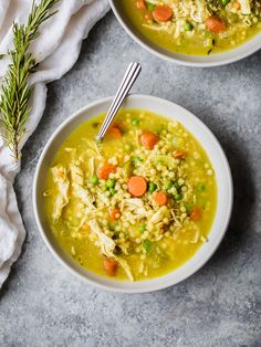 two bowls of chicken and barley soup with carrots, celery, and parsley