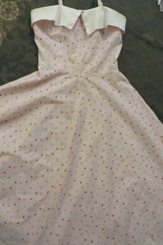 "Vintage/antique HOMEMADE DRESS as shown.  The fabric looks to me, like a feed sack from the 1940's.  Great for \"GREASE\" Costuming, or the like.  Measurements:   Bust is 32\"  Waist is 26 1/2\"  Length from the shoulder top of the shoulder strap to the hemline is 46\"  In today's ladies size, it's about a size 6.  Back Zipper closure  Two \"Spaghetti Straps\" - Sleeveless, vintage dress.  Summer dress.  Flared Skirt I've laundered the dress.  I soaked and treated the underarm stains.   Condition:  Very good Vintage/used condition.  The only staining is under the arms (shown in last picture)  No holes that I can see/find." Vintage Sleeveless Dress For Tea Party, Cotton A-line Vintage Dress, 1950s Cotton Dress With Vintage Pattern, 1950s Style Lined Cotton Vintage Dress, 1950s Vintage Pattern Cotton Dress, Vintage Cotton Dresses With Vintage Pattern, Cotton Vintage Dress With Vintage Pattern, Vintage A-line Cotton Dress, Retro Cotton Wedding Dress