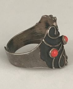 "Three small bezel set red stones adorn the face of this ornate ring. The face is about 3/4\" long. The ring is currently a size 7 1/2,but is adjustable. It is marked Sterling Taxco Mexico. It is in beautiful preloved condition. Please see all photos for details, as well as, condition. Thank you for looking!" Ornate Ring, Red Stones, Vintage Sterling Silver Rings, Red Band, Eye Ring, Red Stone, Silver Enamel, Green Stone, Bezel Setting