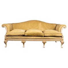 an old fashioned couch with two pillows on it's back and armrests