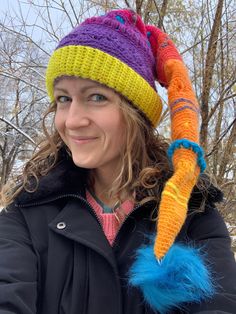 a woman wearing a colorful knitted hat and scarf