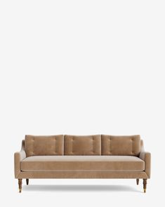 a beige couch with wooden legs on a white background and an empty wall behind it