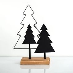 two black trees are sitting on a wooden stand