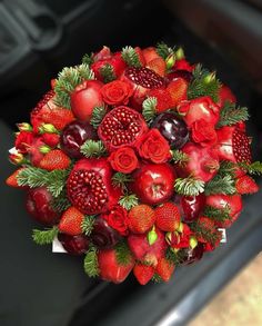 a bouquet of strawberries, apples and pomegranates